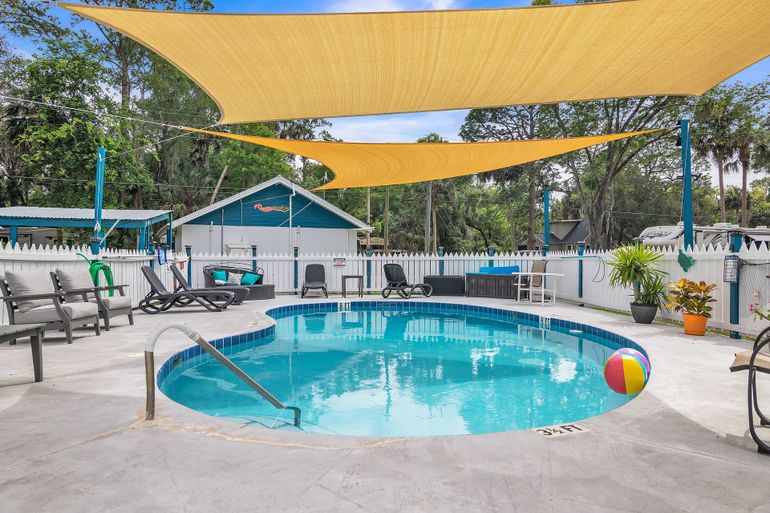 a swimming pool with a yellow canopy over it