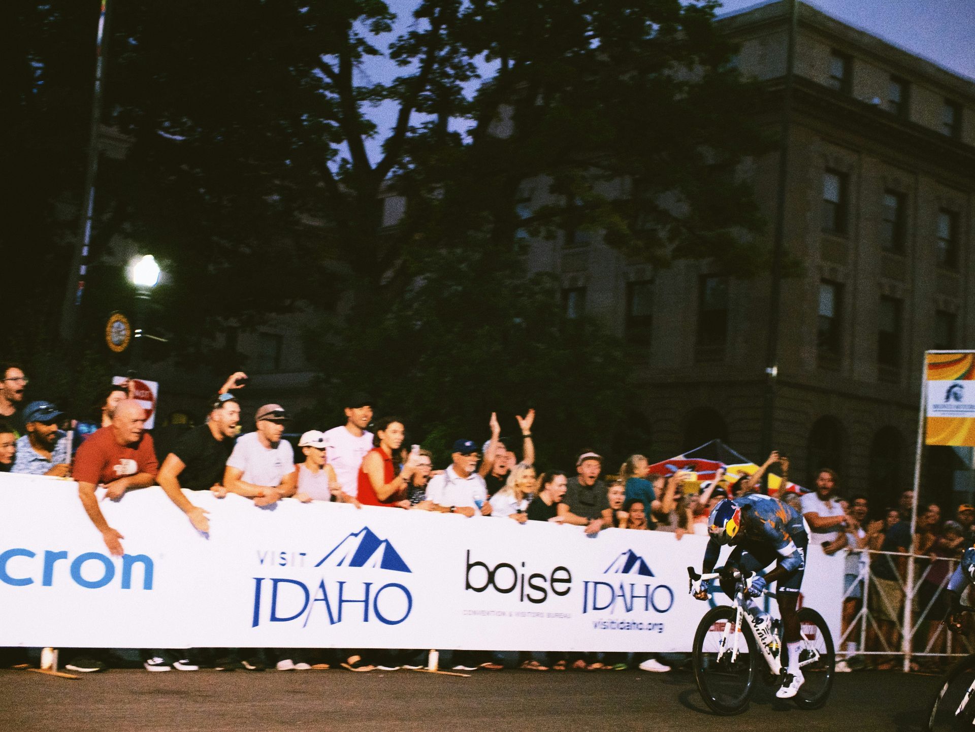 A person riding a bike in front of a sign that says idaho