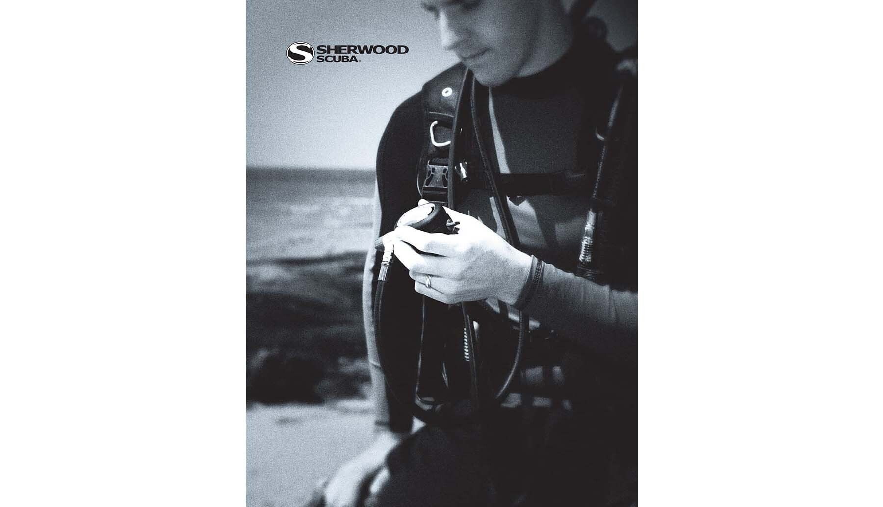 A black and white photo of a man looking at his phone