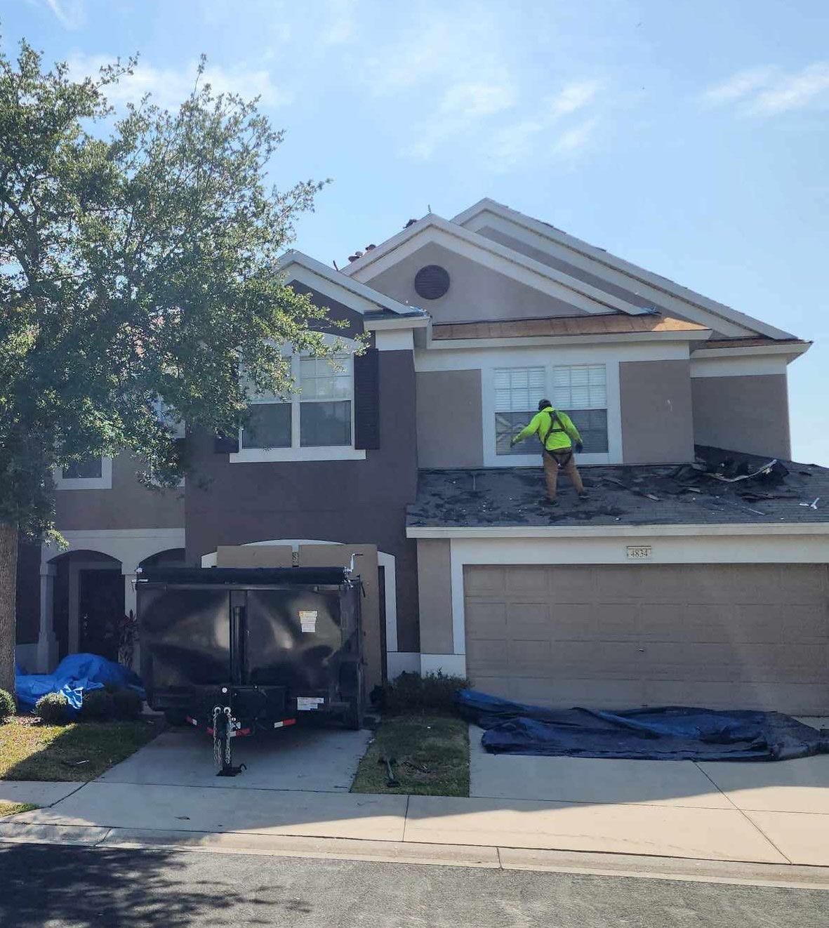Worker Repairing a Residential Roof