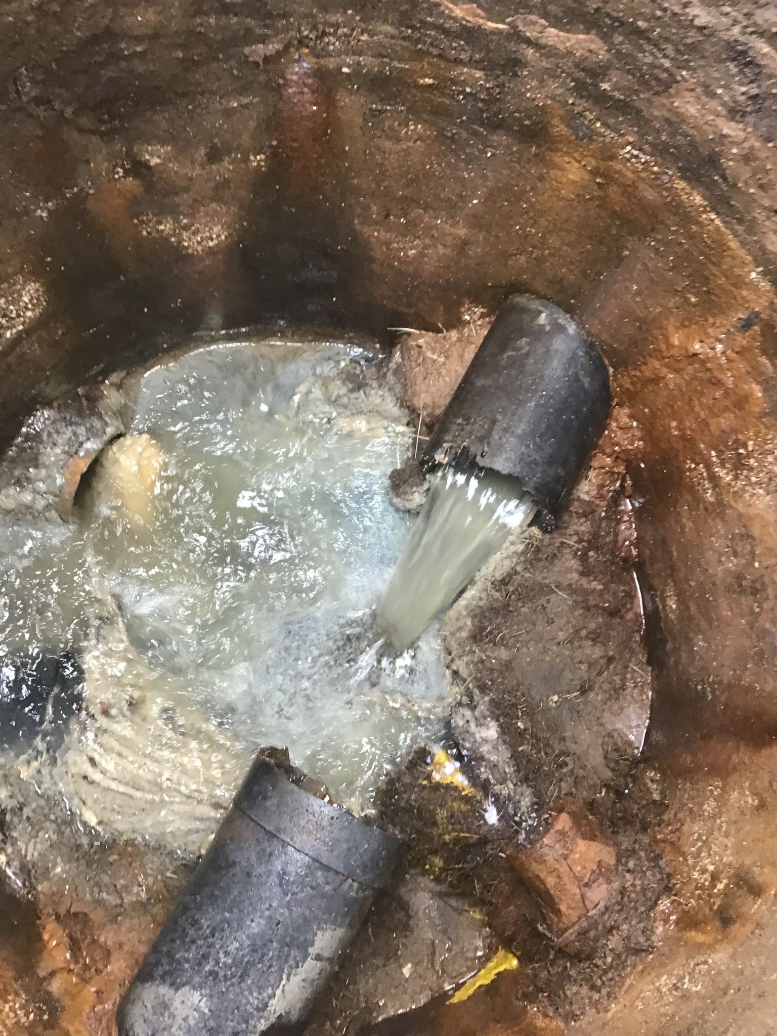 A close up of a pipe with water coming out of it.