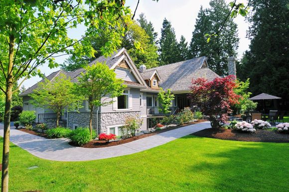 A large house with a lush green lawn in front of it