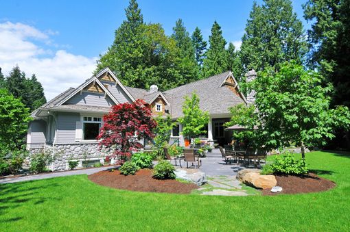 A house with a large lawn in front of it