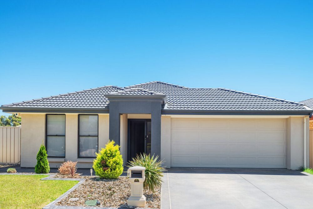 Single-story Beige House With a Gray Roof and Driveway — Country Coast Valuers in Forster, NSW