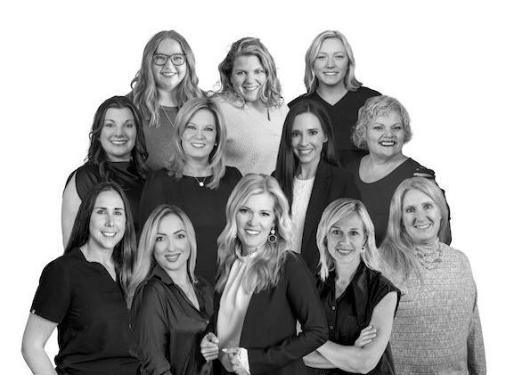 A group of women are posing for a picture together.