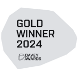 Gold Winner award badge from the Davey Awards 2024. Grey abstract shape with black text.