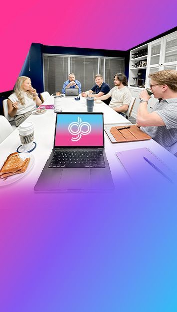 Laptop on a table in a meeting, with people sitting around. Gradient overlay effect.