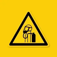Yellow warning sign showing a worker wearing a hard hat next to a fire extinguisher.