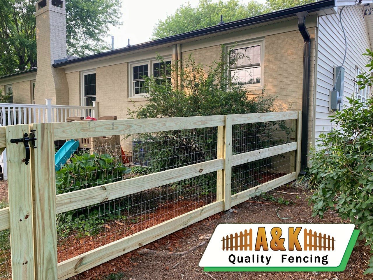 A wooden horse zone fence is sitting in front of a house.