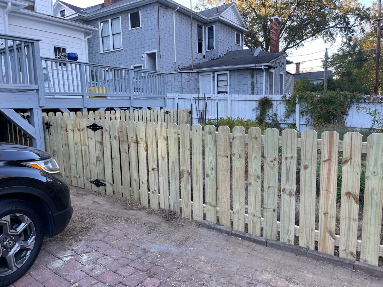 A  wooden Pine Pickets fence.