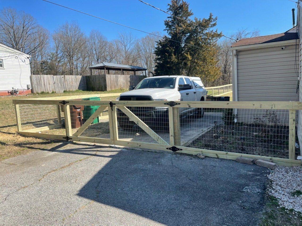 A wooden two rails with wire fence