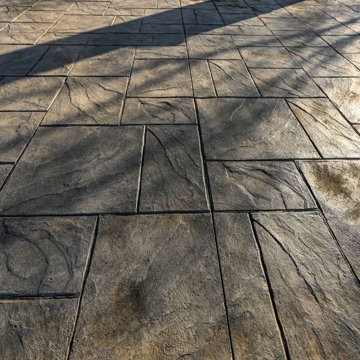 A tiled floor with a tree shadow on it