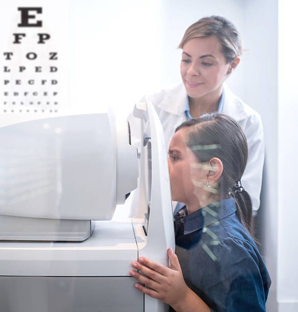Child undergoing an eye exam at the doctor for vision and health. 
