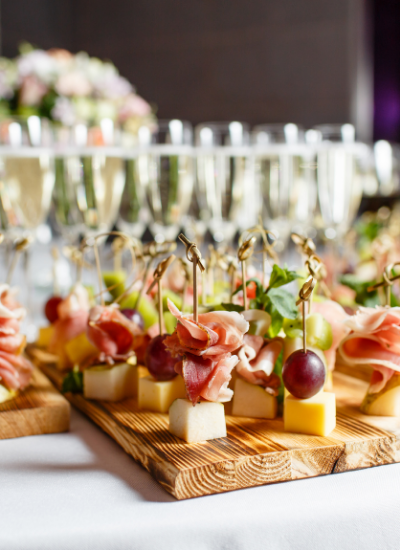 Elegant appetizer skewers and champagne glasses on a banquet table