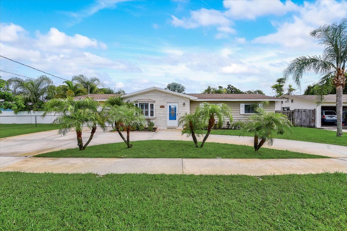 A vase of flowers is sitting on a table next to a window.