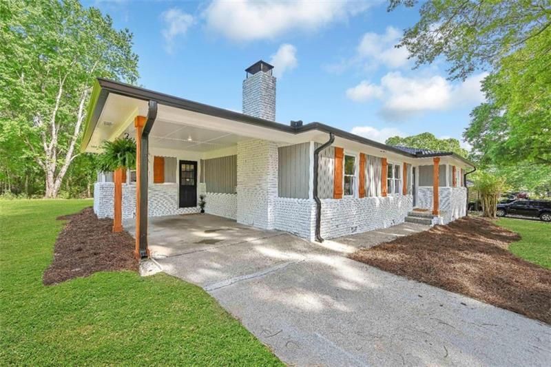 A patio with a lot of furniture and lights at night.