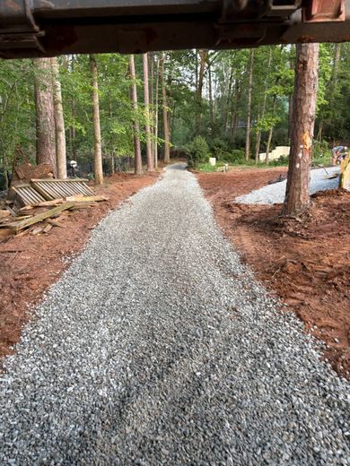 A gravel road in the middle of a forest.