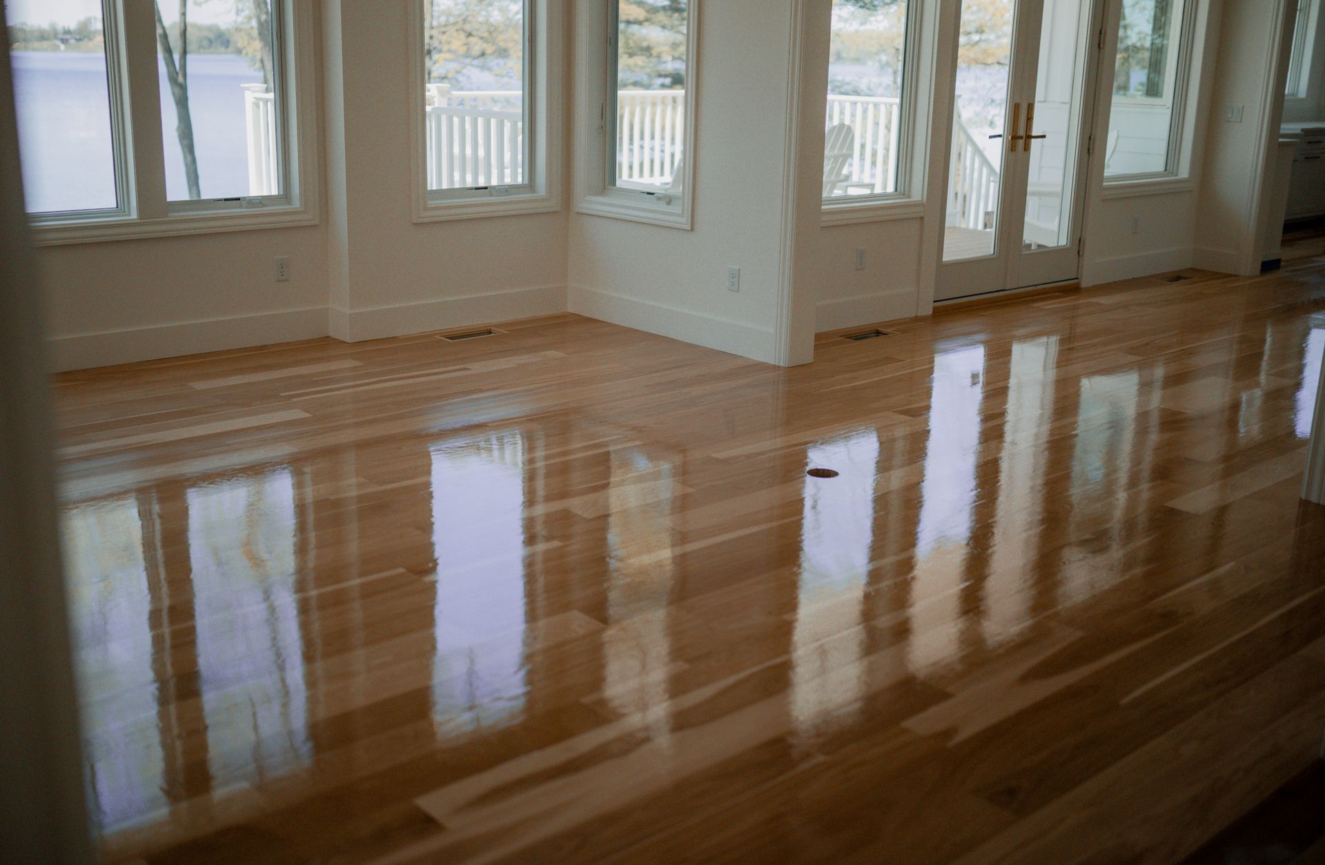 A living room with hardwood floors and lots of windows.
