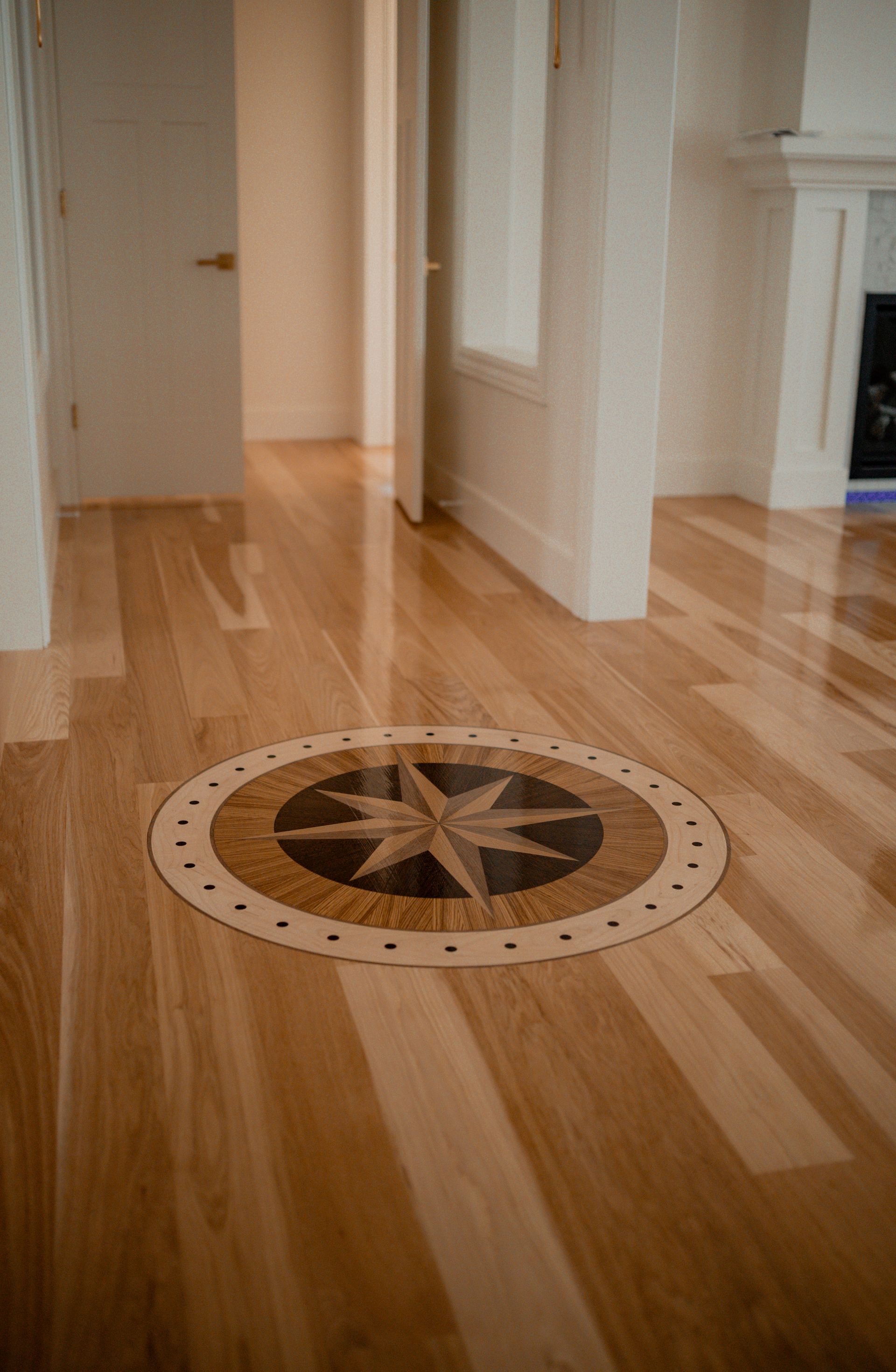 A wooden floor with a compass in the middle of it.