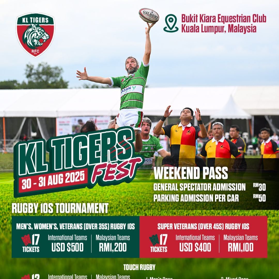 A man is holding a rugby ball in the air at a kltigers fest