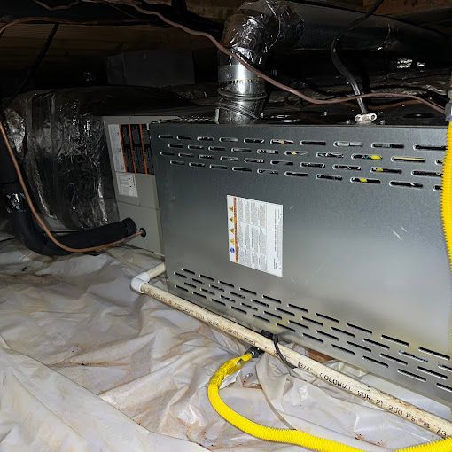 A metal box with a yellow hose attached to it