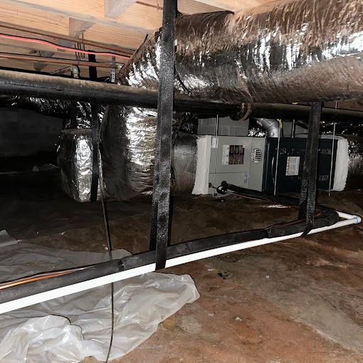 A basement with a lot of pipes and ducts