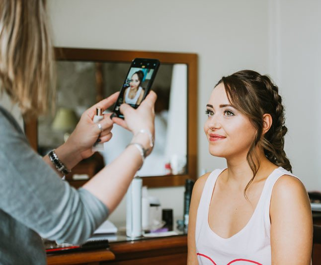 Jackie is making sure the bridesmaids hair and makeup is picture perfect