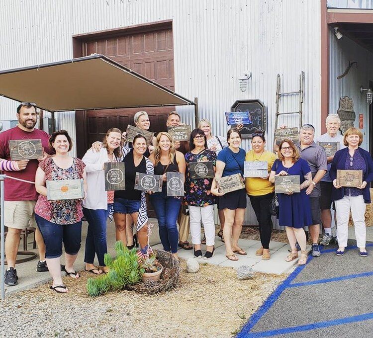 A group of people standing in front of a building holding signs