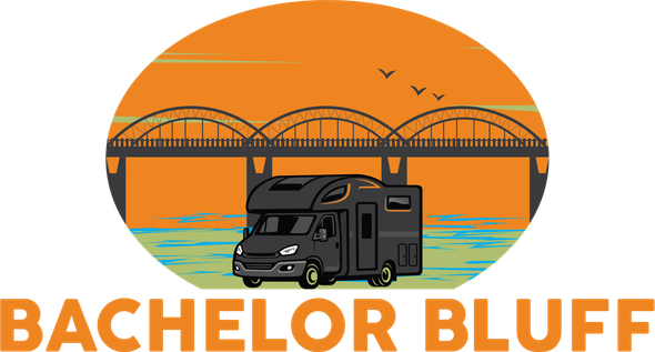RV in front of a bridge, with an orange sunset background.