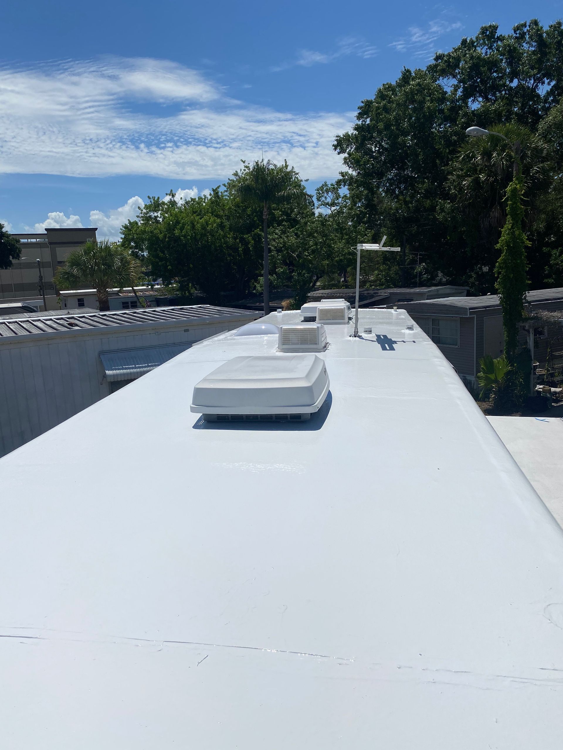 Roofing service advertisement with logo, 10 year warranty, and contact info. Green background with text in white, red and black.