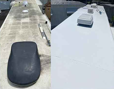 A person stands on the roof of a large vehicle in a cluttered indoor space.