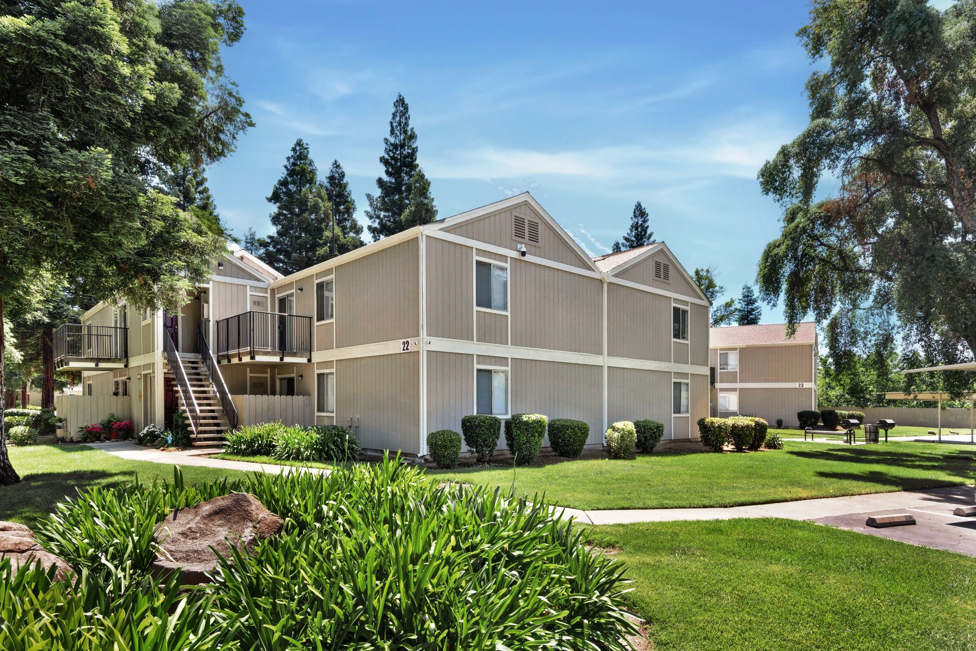 A living room with a wooden coffee table, gray sofa, and decorative objects.