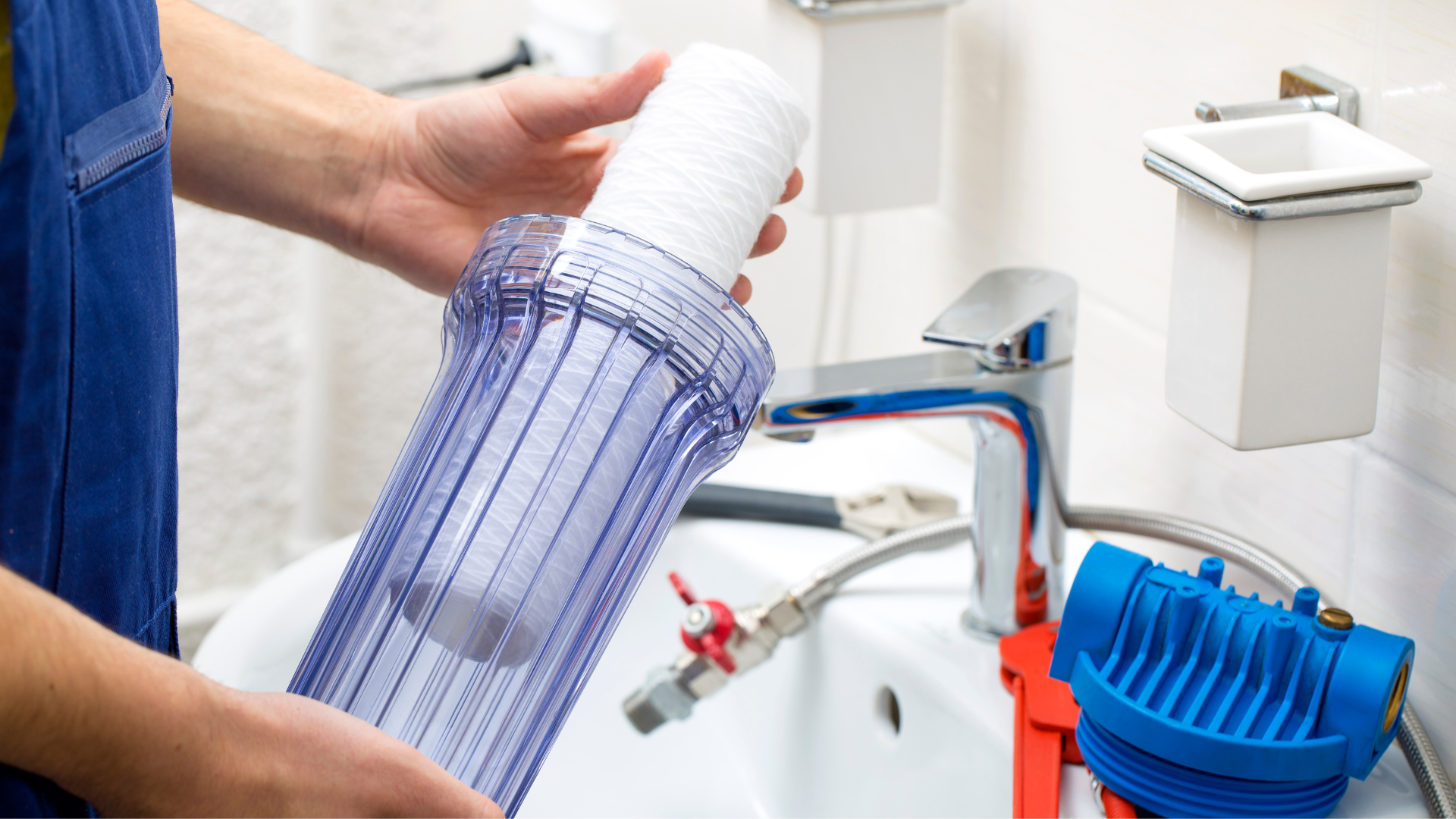 A person is cleaning a water filter in a bathroom.