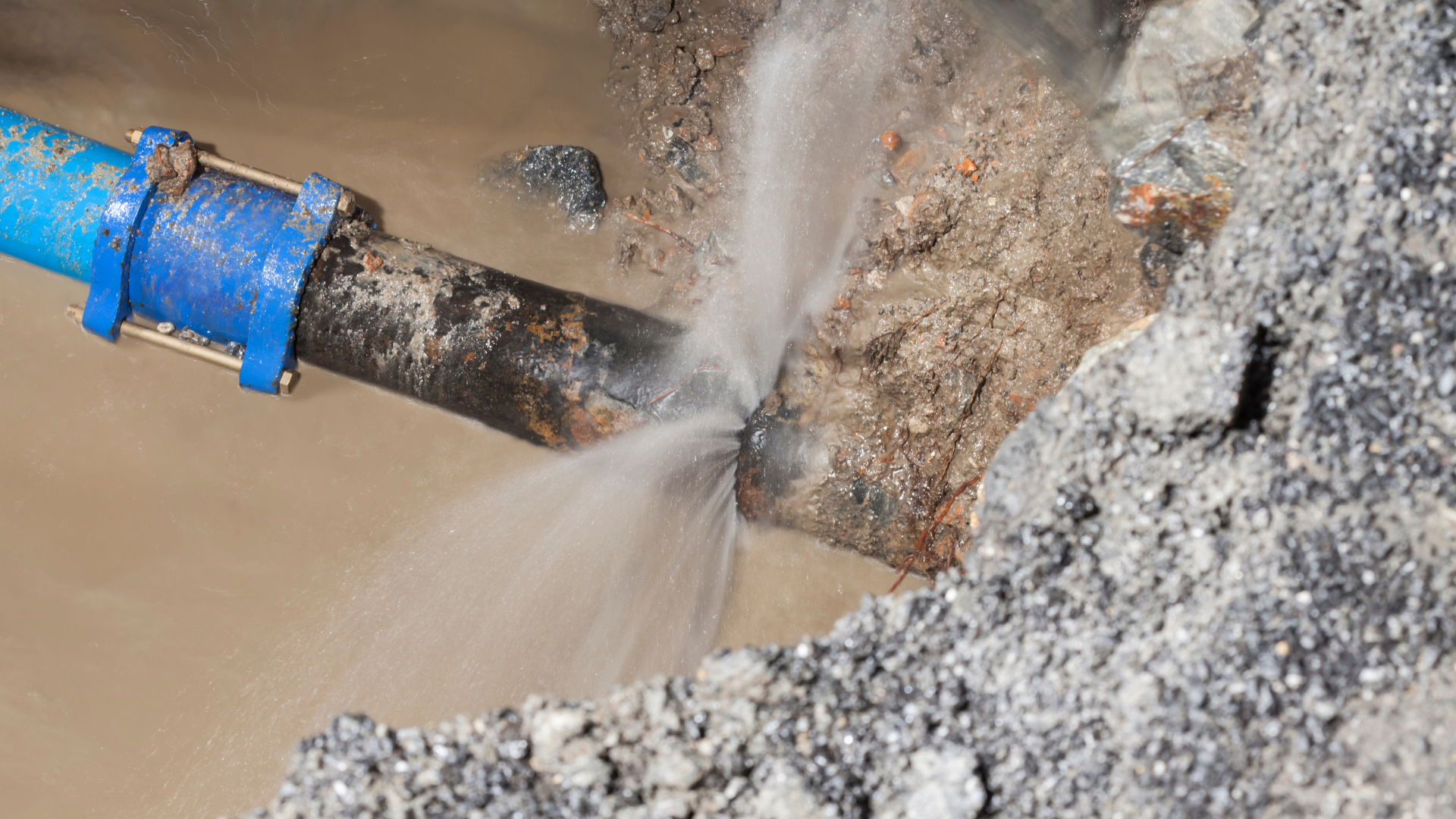 A water pipe is leaking water into the ground.