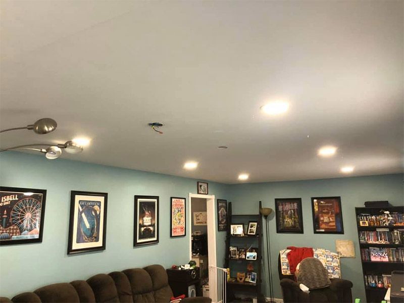A living room with a couch and a lot of pictures on the wall