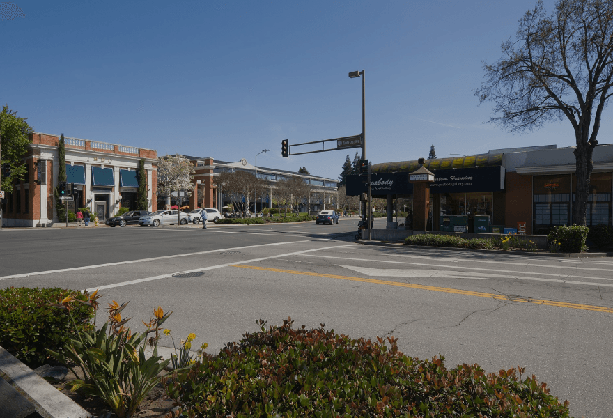A busy intersection with a few buildings in the background