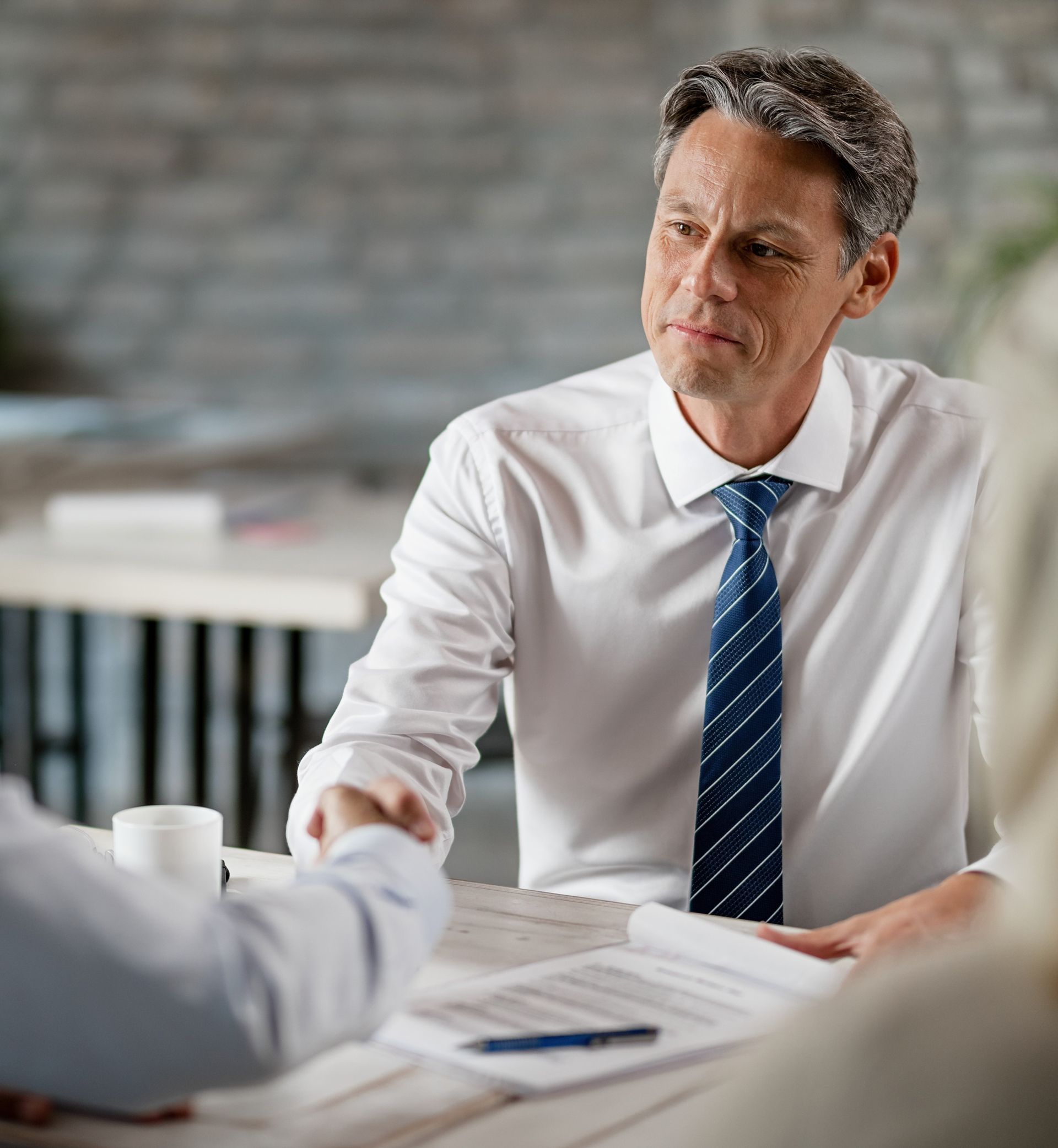 A man is talking to an elderly woman in a wheelchair.