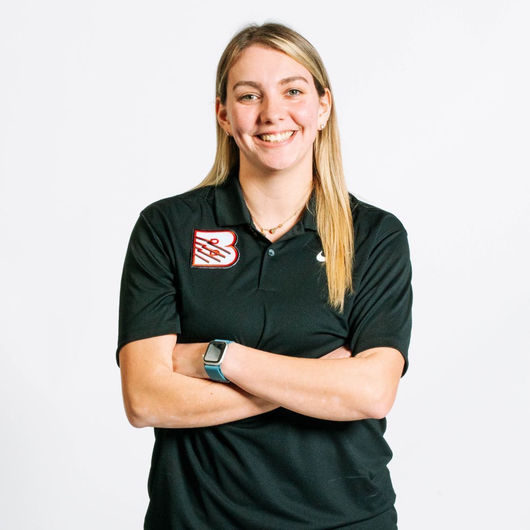 A man wearing a hat and a red shirt that says beast