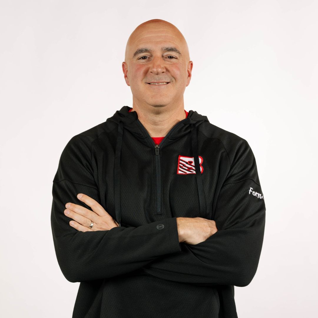 A man wearing a hat and a red shirt that says beast