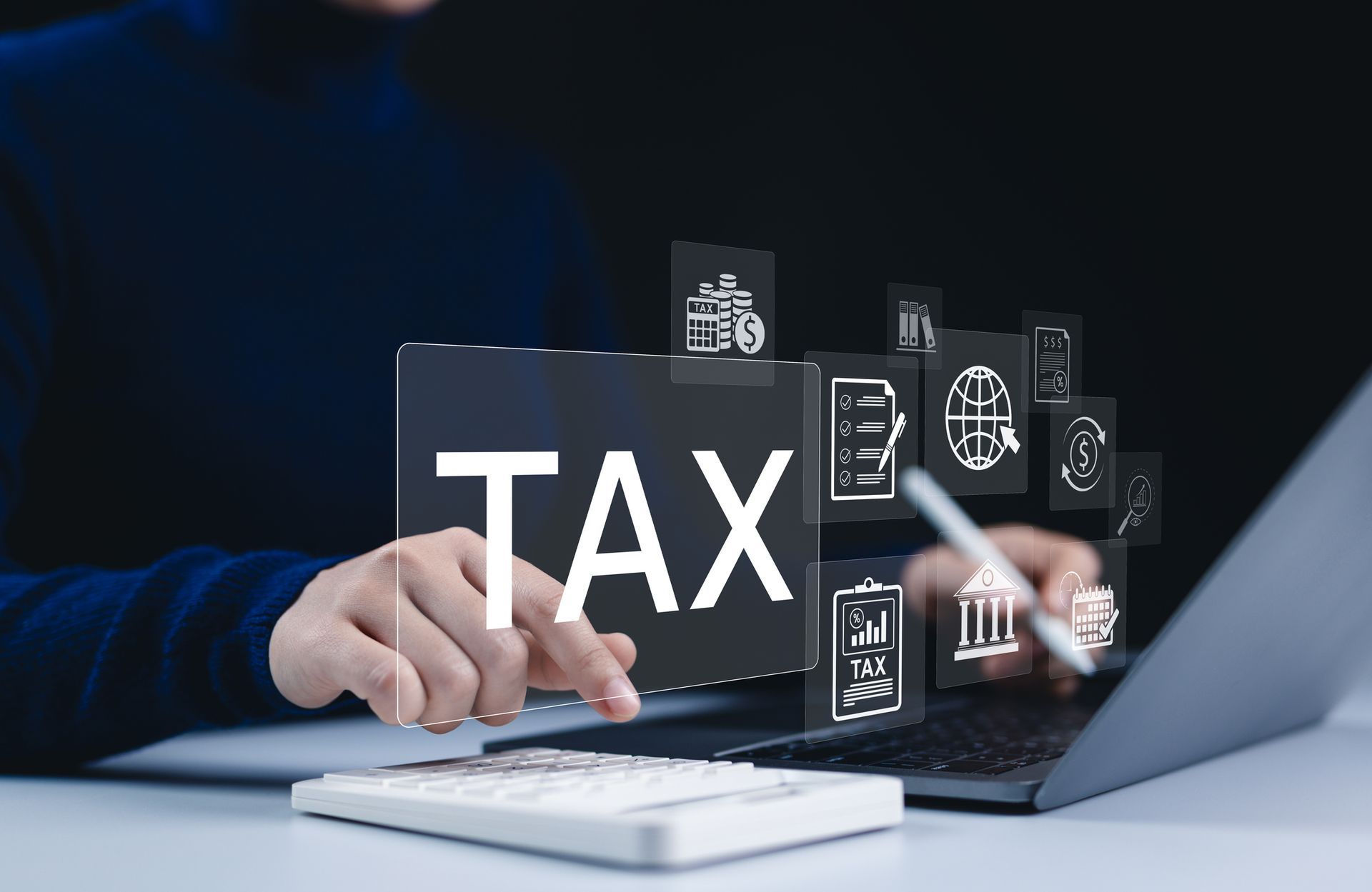 Two people reviewing financial documents, using a calculator and laptop at a desk. Two people reviewing financial documents, using a calculator and laptop at a desk.