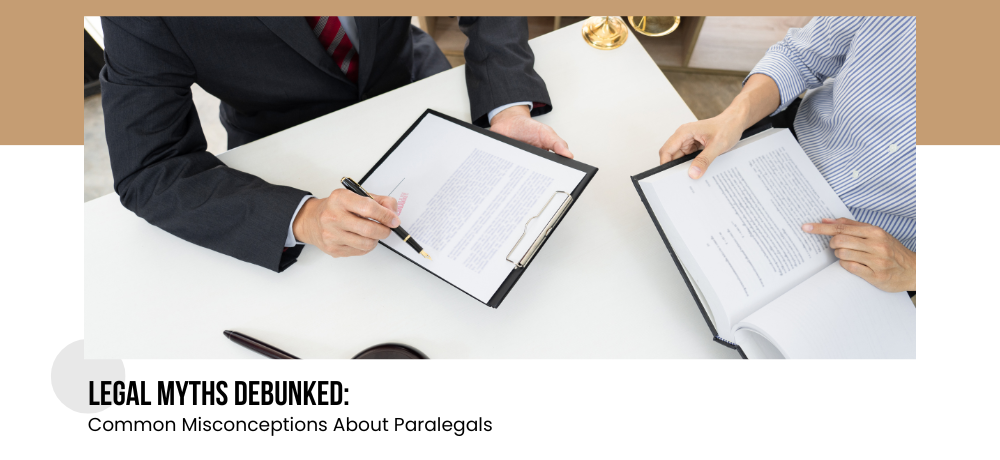 A man and a woman are sitting at a table looking at papers.