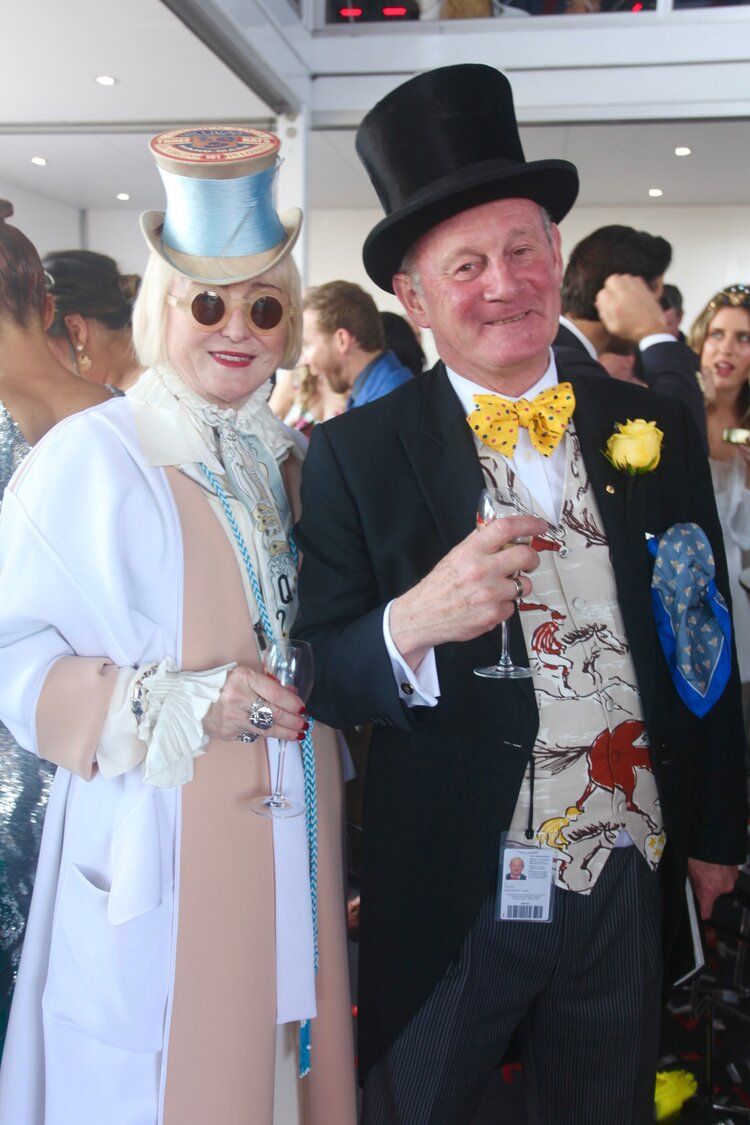 A man in a top hat is standing next to a woman