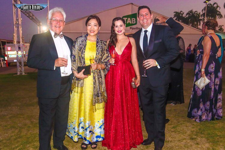 A group of people are posing for a picture in front of a tent.