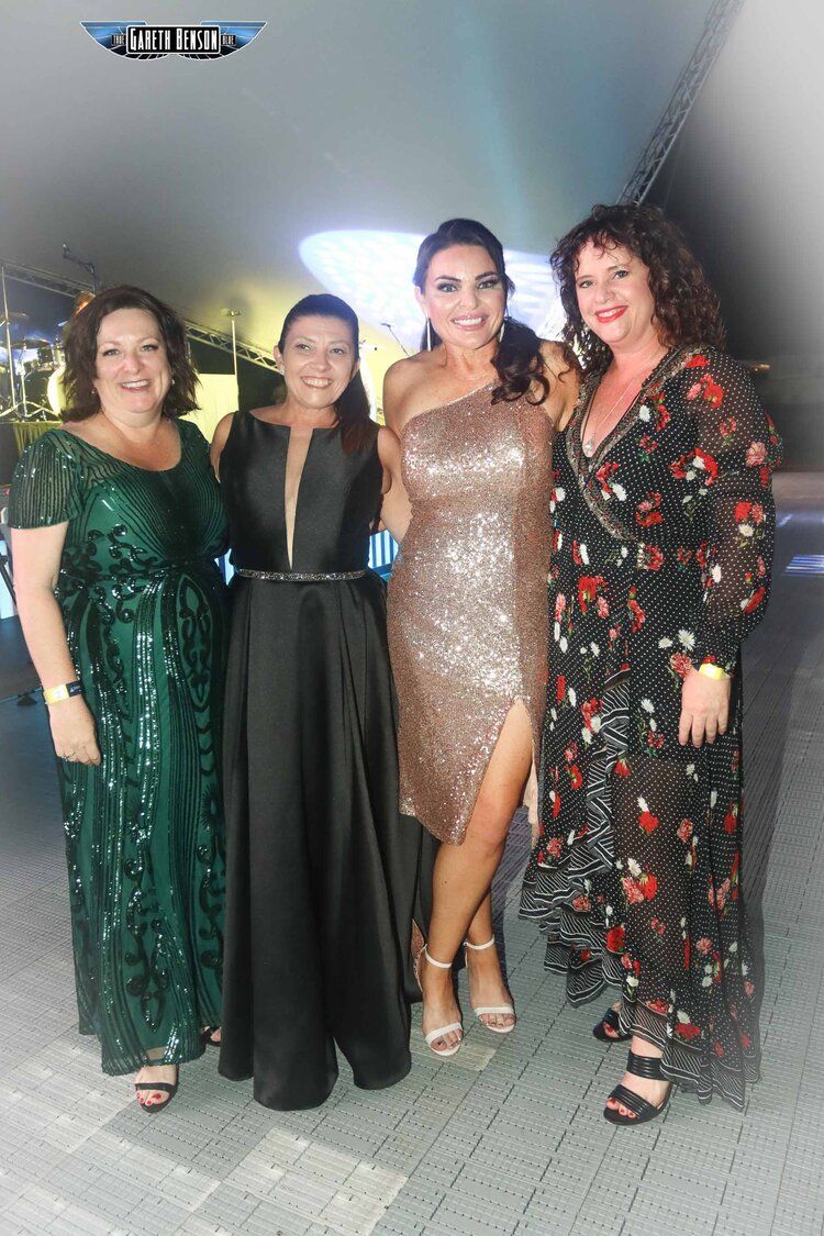 A group of women are posing for a picture together.