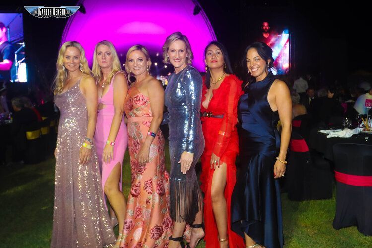 A group of women are posing for a picture together