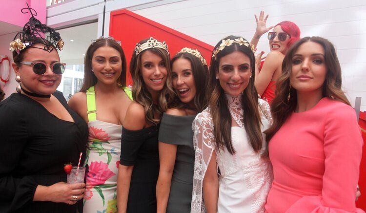 A group of women are posing for a picture together.