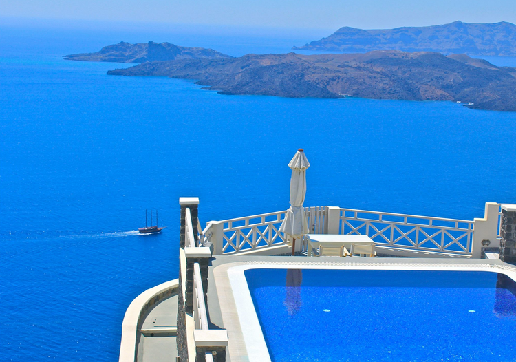 A swimming pool with a view of the ocean and mountains