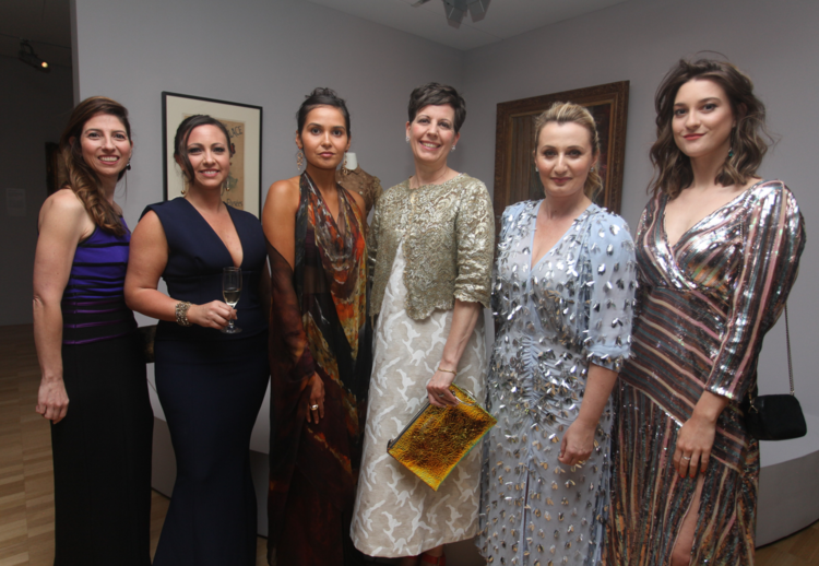 A group of women are posing for a picture together.