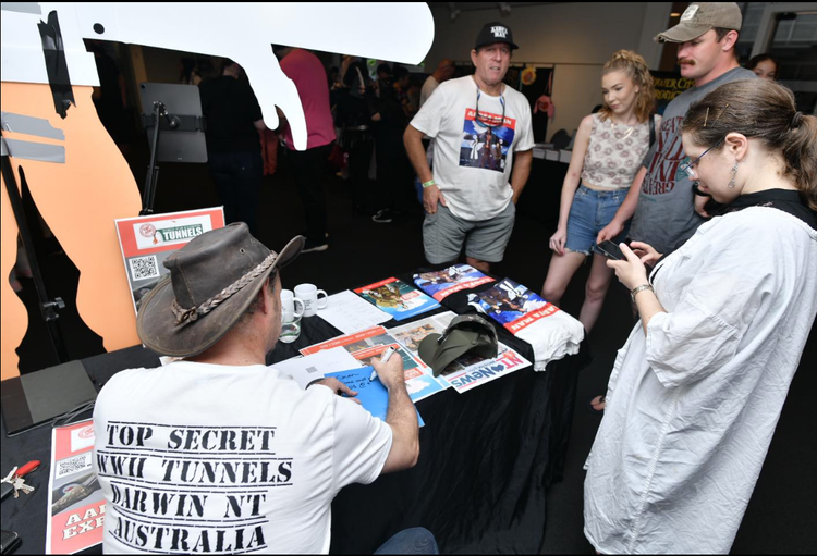 A man wearing a shirt that says top secret air tunnels