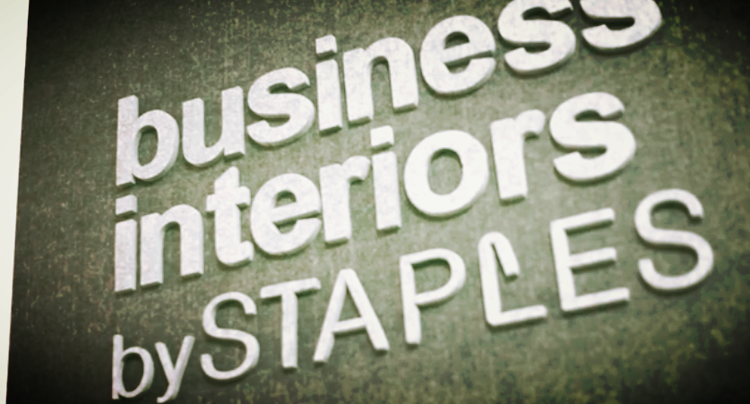 A sign that says business interiors by staples on it